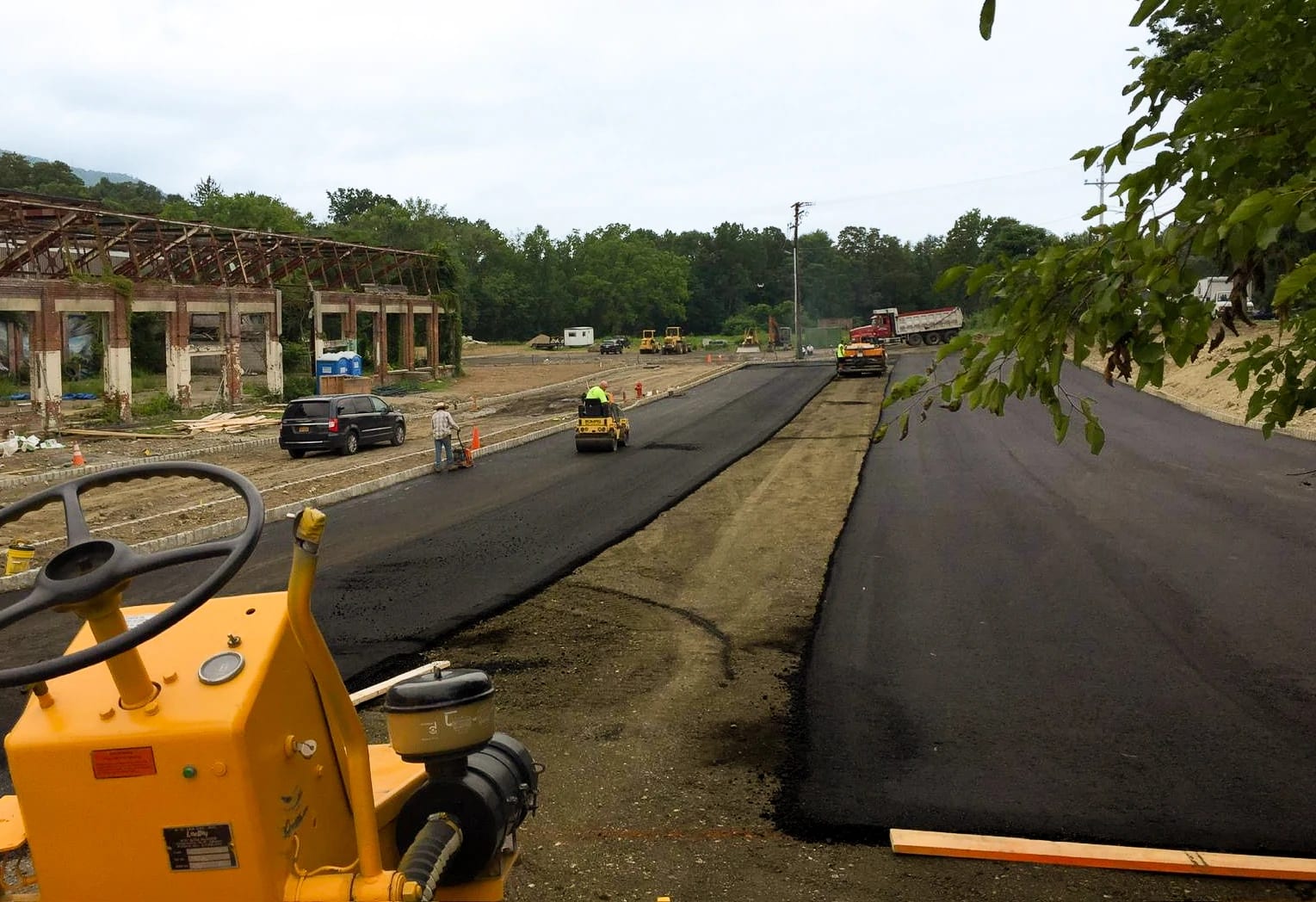 Asphalt paving and road rollers beside the former mill buildings at Lofts at Beacon
