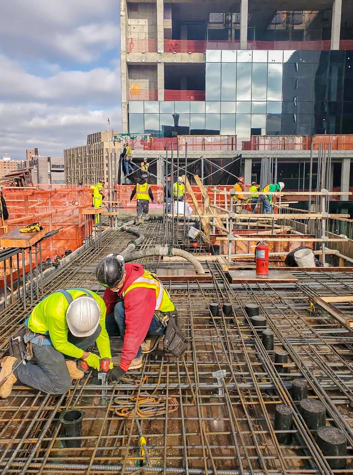 Construction crews installing a reinforced concrete floor structure