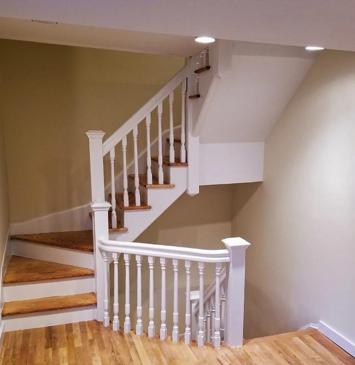Wood stairs and flooring with white railings
