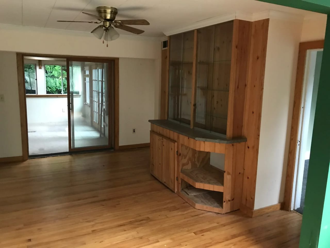 Wood-paneled interior with shelving and a glazed opening