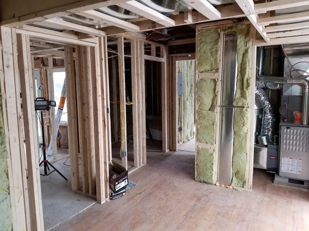 Interior partition framing and insulation beside mechanical equipment