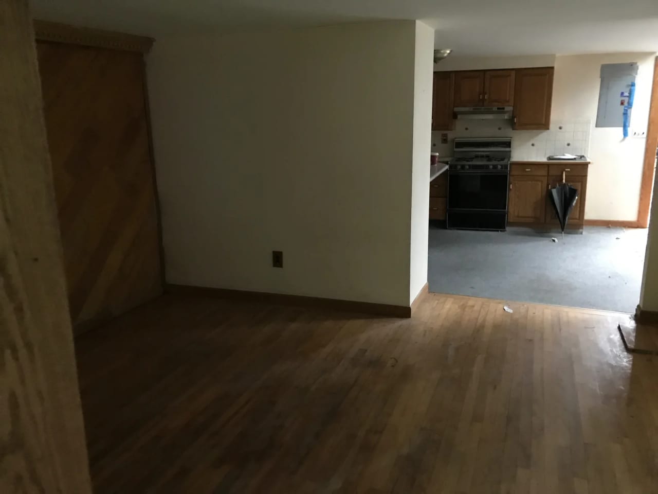View toward wood-front kitchen cabinets around a projecting partition