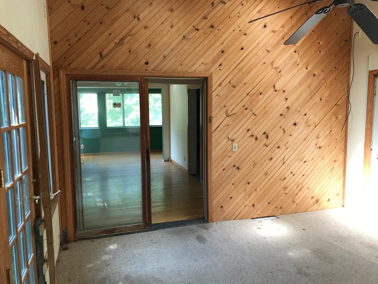Original room with diagonal wood paneling and glazed openings